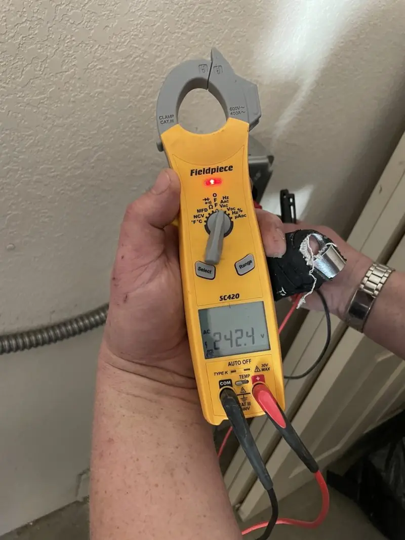 Voltage testing with clamp meter during Whole House Surge Protector in Johnson